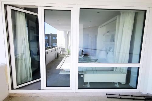 a room with two large sliding glass doors at HH 03 Modernes Apartment am Winterhuder Marktplatz in Hamburg