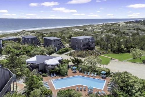 an aerial view of a house with a pool and the beach at Unit 1912 Ocean Colony Beach in Amagansett