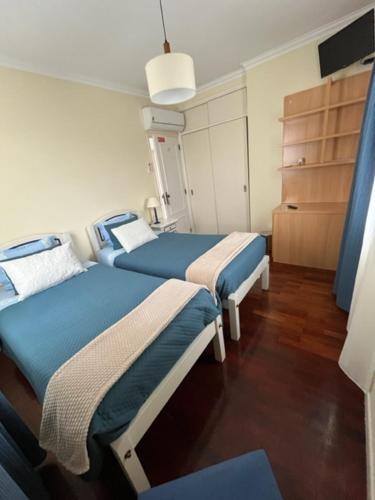 a hospital room with two beds and a dresser at Quinta de Vale Escuro in Lousã