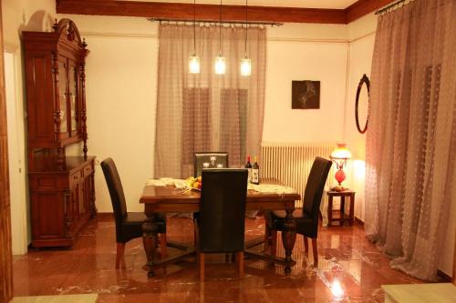 una sala da pranzo con tavolo e sedie in legno di Edem House a Volos