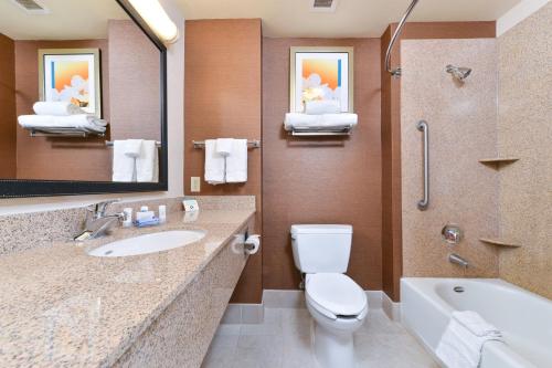 a bathroom with a toilet and a sink and a tub at Fairfield Inn and Suites by Marriott Elk Grove in Elk Grove