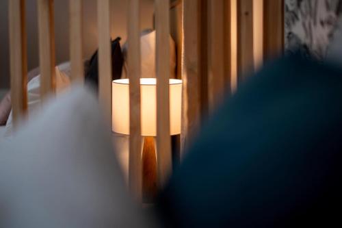 a lamp in a room next to a stair railing at Appart-hôtel de standing avec jacuzzi privatisable en option in Périgueux