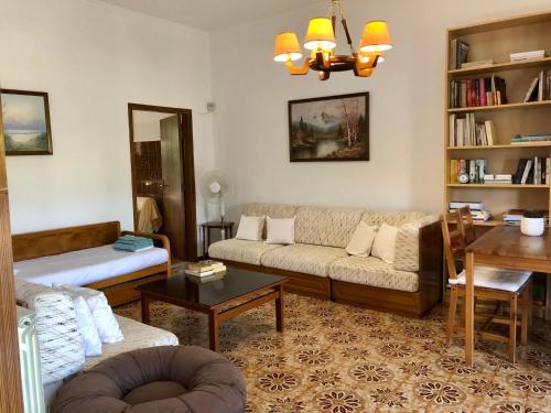 a living room with a couch and a table at Lemon tree's house in Kalavárda