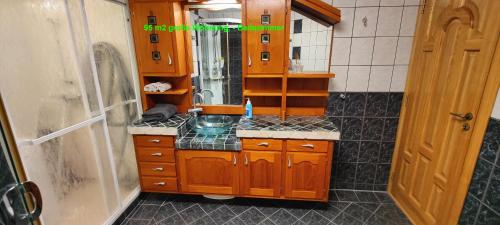 a bathroom with a sink and a mirror in it at Åkrehamn Marina in Åkrehamn