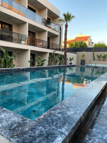 a swimming pool in front of a building at No 22 Residence in Cesme