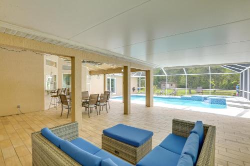 a living room with a couch and chairs and a pool at Private Fort Myers Escape with Screened Pool and Lanai in Fort Myers
