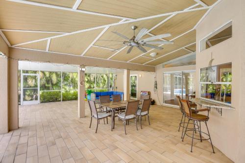 a dining room with a ceiling fan and a table and chairs at Private Fort Myers Escape with Screened Pool and Lanai in Fort Myers