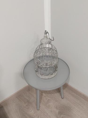 a glass bird cage sitting on a table at Appartamento Piazzetta La Maddalena in Savona