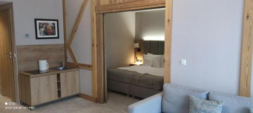 a small bedroom with a bed and a mirror at APARTAMENT w PLATINUM MOUNTAIN in Szklarska Poręba