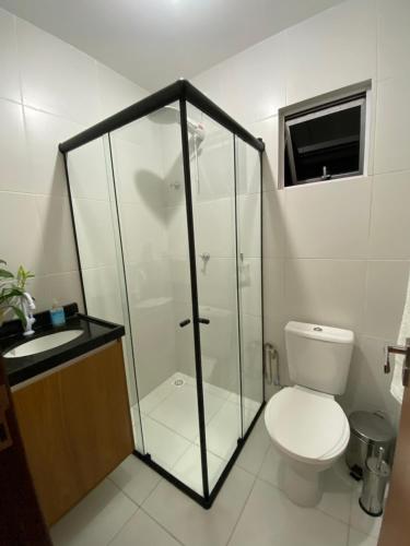 a bathroom with a shower and a toilet and a sink at Flat em Campina Grande in Campina Grande