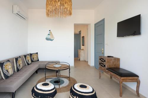 a living room with a couch and a table at Galazio Seaside Luxury Rooms & Coffee Shop in Platamonas