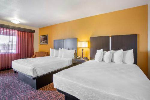 a hotel room with two beds and a window at Best Western Arizonian Inn in Holbrook