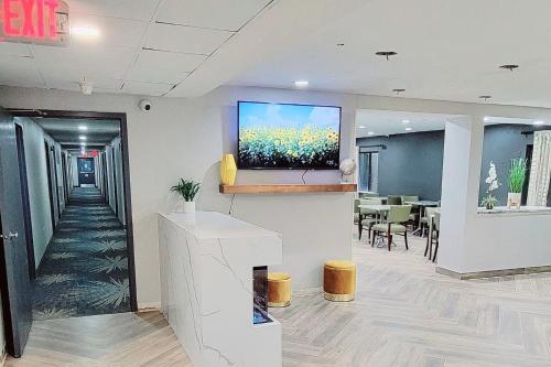 a waiting room with a flat screen tv on a wall at Days Inn by Wyndham Pleasant Prairie Kenosha in Kenosha