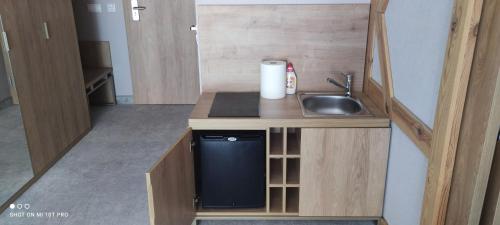 a small kitchen with a sink and a dishwasher at APARTAMENT w PLATINUM MOUNTAIN Z PARKINGIEM in Szklarska Poręba