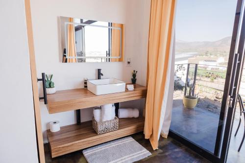 a bathroom with a sink and a mirror at Starlight bungalow queen 4 in El Porvenir