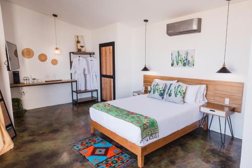 a bedroom with a bed and a table and a mirror at Starlight bungalow queen 4 in El Porvenir
