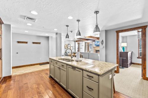 a kitchen with a sink and a counter top at Mountainside Ski Lodge in Park City