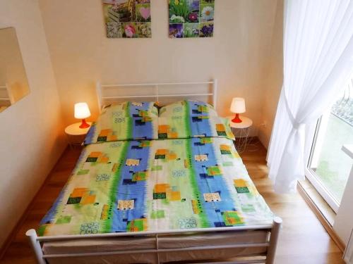 a bed with a colorful quilt on it in a bedroom at Pokoje gościnne Zofia Narloch in Władysławowo