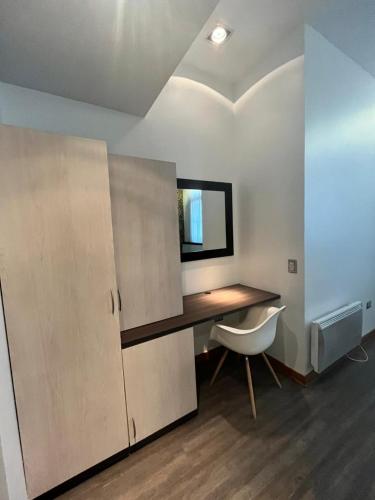 a room with a desk with a chair and a mirror at BHB Hotel Boutique in Santiago