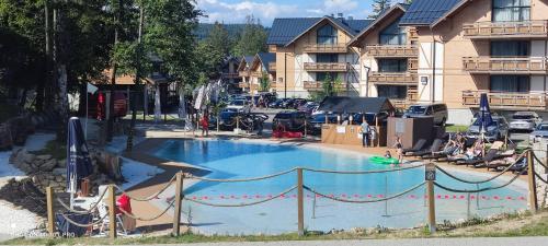 a large swimming pool in front of a resort at APARTAMENT w PLATINUM MOUNTAIN Z PARKINGIEM in Szklarska Poręba