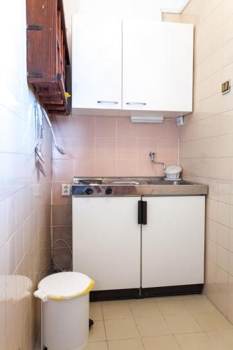 a small kitchen with a sink and a toilet at Villa Lavanda in Pag
