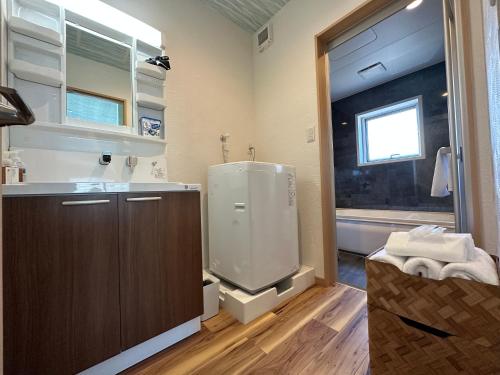 a bathroom with a shower and a sink and a window at 09 Resort Club -Green- in Azagawa