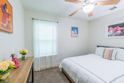 a bedroom with a bed and a ceiling fan at Hidden Gem in San Antonio