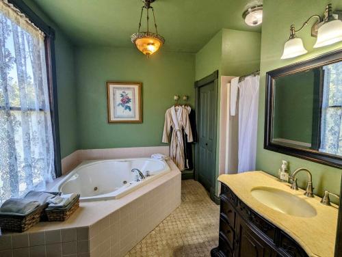 a bathroom with a large tub and a sink at Swantown Inn in Olympia