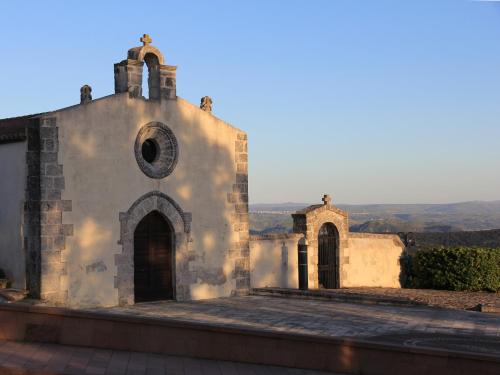 an old building with a tower and a church at Brancadoria B&B in Monteleone Rocca Doria