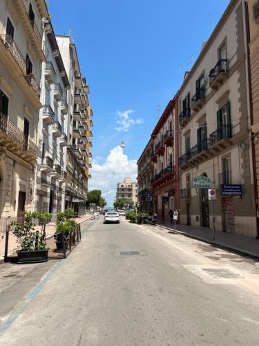 an empty city street with a car driving down the street at Suite Cavour Luxury Home Taranto in Taranto