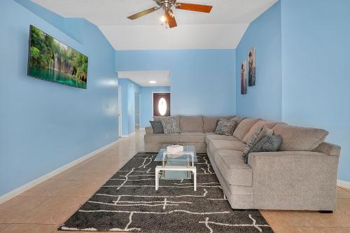 a living room with a couch and a table at Luxury Villa in Orlando with Pool - 10 min Disney in Orlando