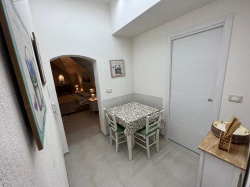 a room with a table and chairs in a room at Suite Cavour Luxury Home Taranto in Taranto