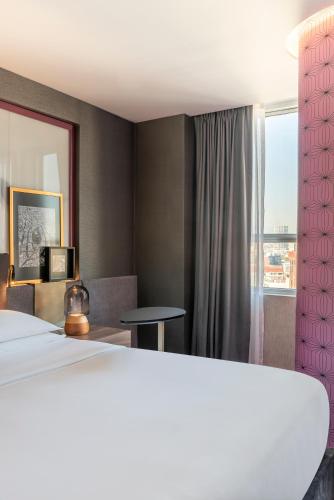 a hotel room with a large bed and a window at Andaz Condesa Mexico City, By Hyatt in Mexico City