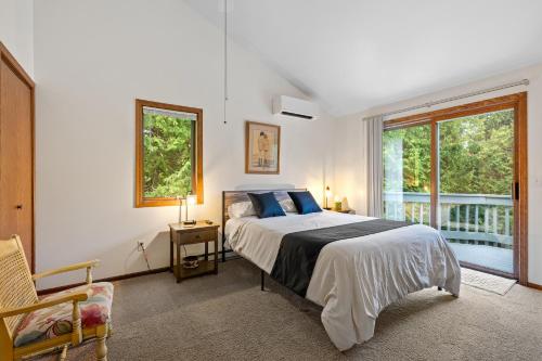 a bedroom with a large bed and a window at Stone Ridge Baileys Harbor in Baileys Harbor