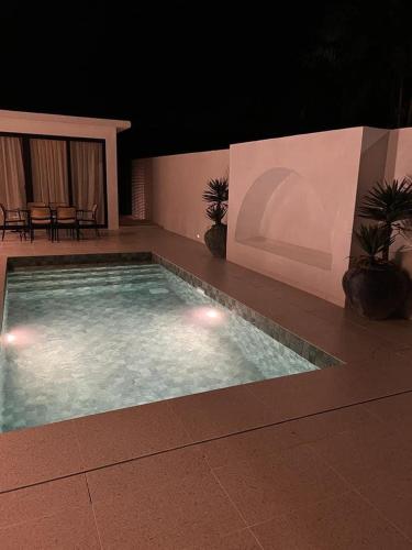 a large swimming pool in a building at night at Arau House in Arau