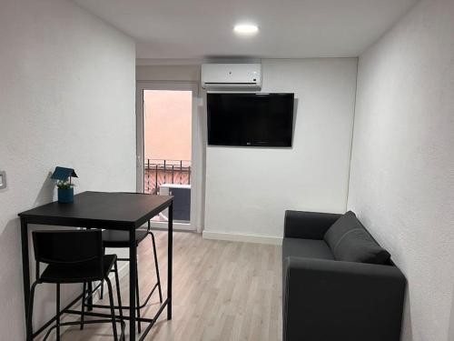 a living room with a table and a couch at Piso en el centro de Monistrol de Montserrat in Monistrol