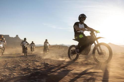 a group of people riding dirt bikes in the desert at Redrock Riverside Cave 3 - Glamping Cave Suite in Moab