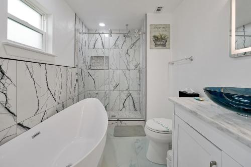 a white bathroom with a toilet and a sink at Luxury Villa in Orlando 4BD/3BA - 14 min Disney in Orlando