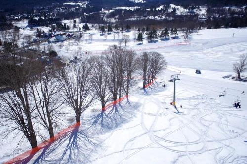a ski slope with skiers and a ski lift at Quechee Condo in Quechee