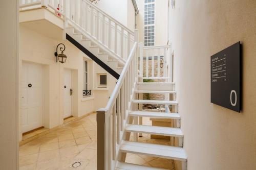 a staircase in a building with a stair sign on the wall at Sonder Quintinie in Paris