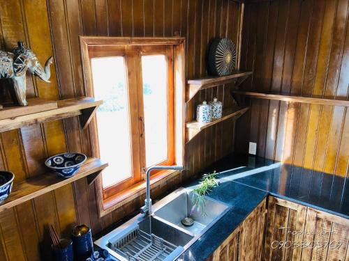 a kitchen with a sink and a window at DuGiang Homestay in Buon Ma Thuot
