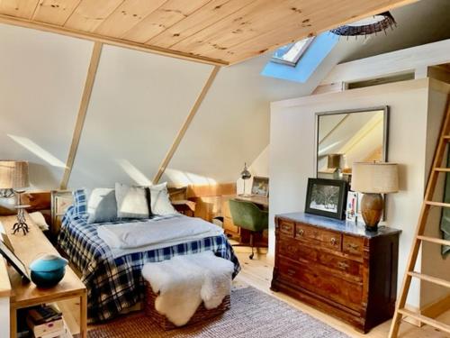 a bedroom with a bed and a dresser and a mirror at Sadawga Springs Retreat in Whitingham