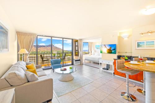 a living room with a couch and a table at Diamond Head Views Retreat with Free Parking & Near Waikiki Beach! in Honolulu