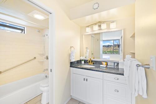 a bathroom with a sink and a tub and a toilet at Diamond Head Views Retreat with Free Parking & Near Waikiki Beach! in Honolulu