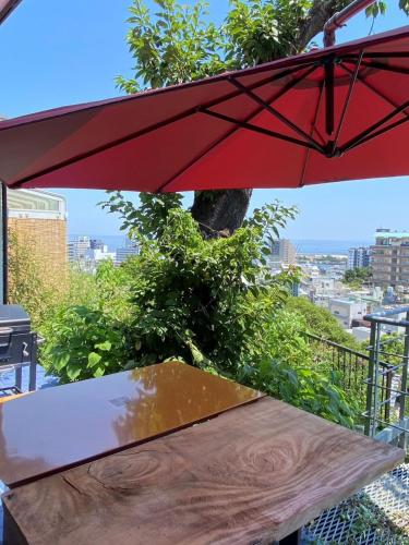 a red umbrella sitting on top of a table at ヴィラマーレ熱海（Villa Mare Atami） in Atami