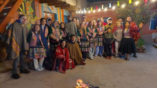 a group of people standing in front of a painting at MUNAY TUPAY in Anansaya