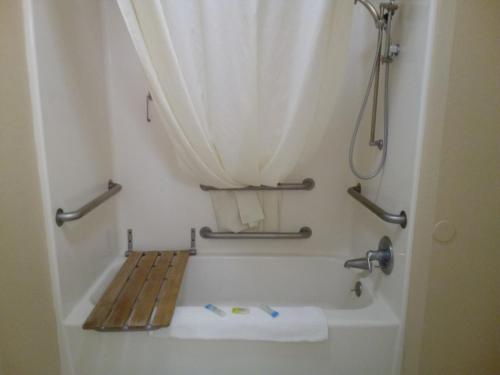 a bathroom with a bath tub with a shower curtain at COPPER STAY INN Benson AZ I-10 Exit 304 in Benson