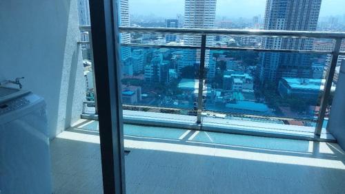 a view of a city skyline from a window at USA embassy front suite Pearl of the Orient in Manila