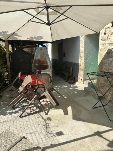 a table and chairs under an umbrella on a patio at Venezia in Abruzzo in Archi