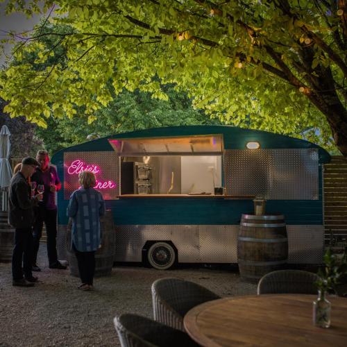 a group of people standing in front of a food truck at The Lancefield Lodge in Lancefield